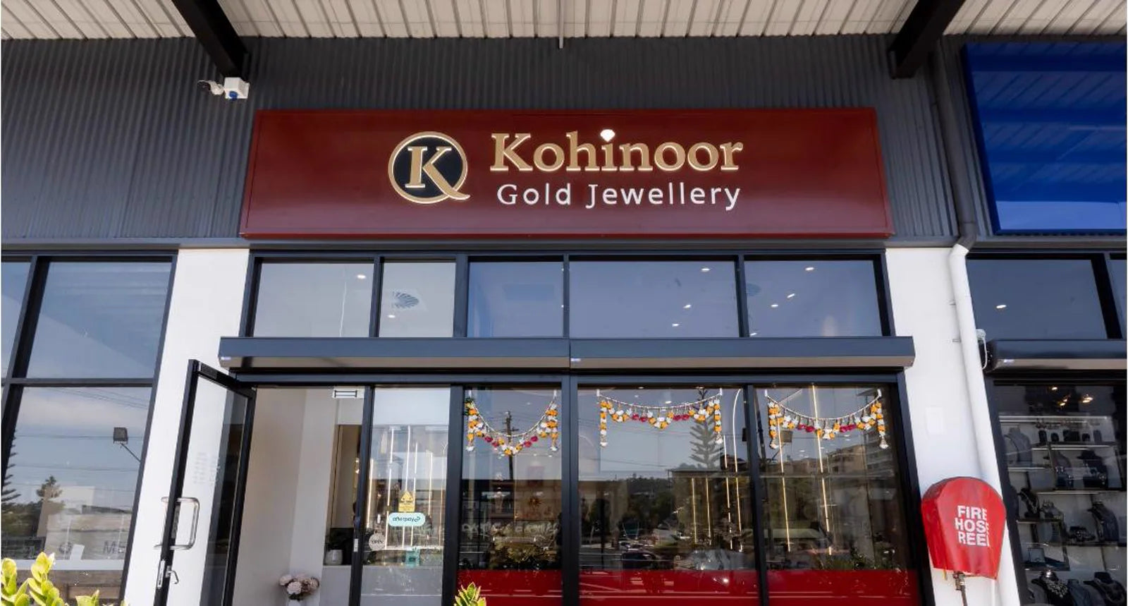 Kohinoor Gold Jewellery storefront with burgundy sign and glass entrance