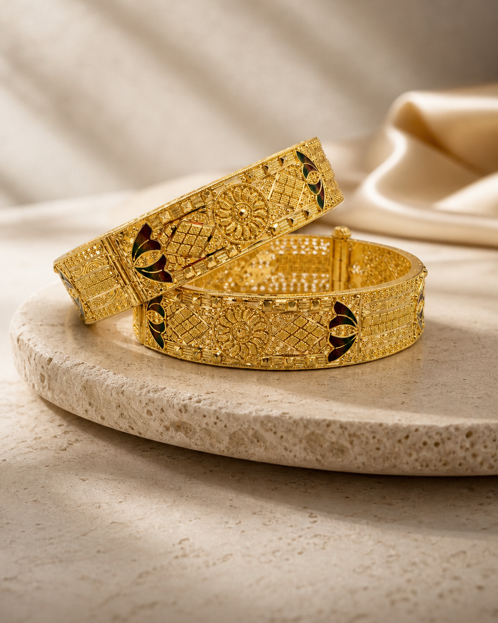 Ornate 22ct gold bangles styled on warm ivory stone