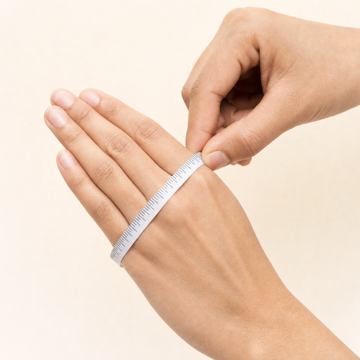 Flexible tape wrapped around the widest part of a closed hand
